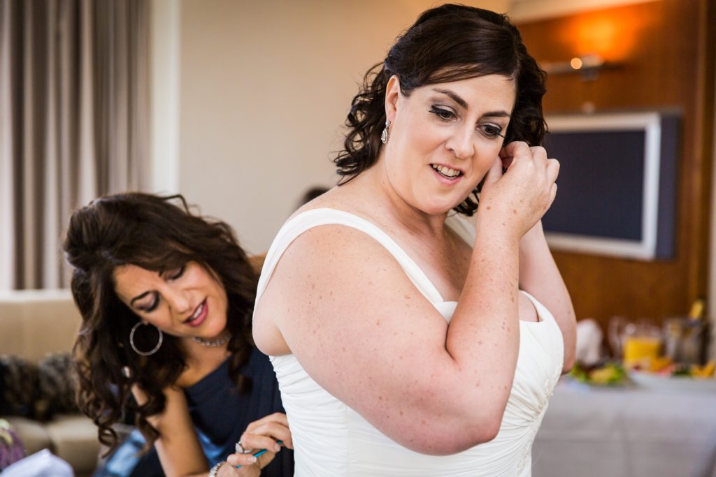 Bride putting on her earrings for a Locanda Verde wedding
