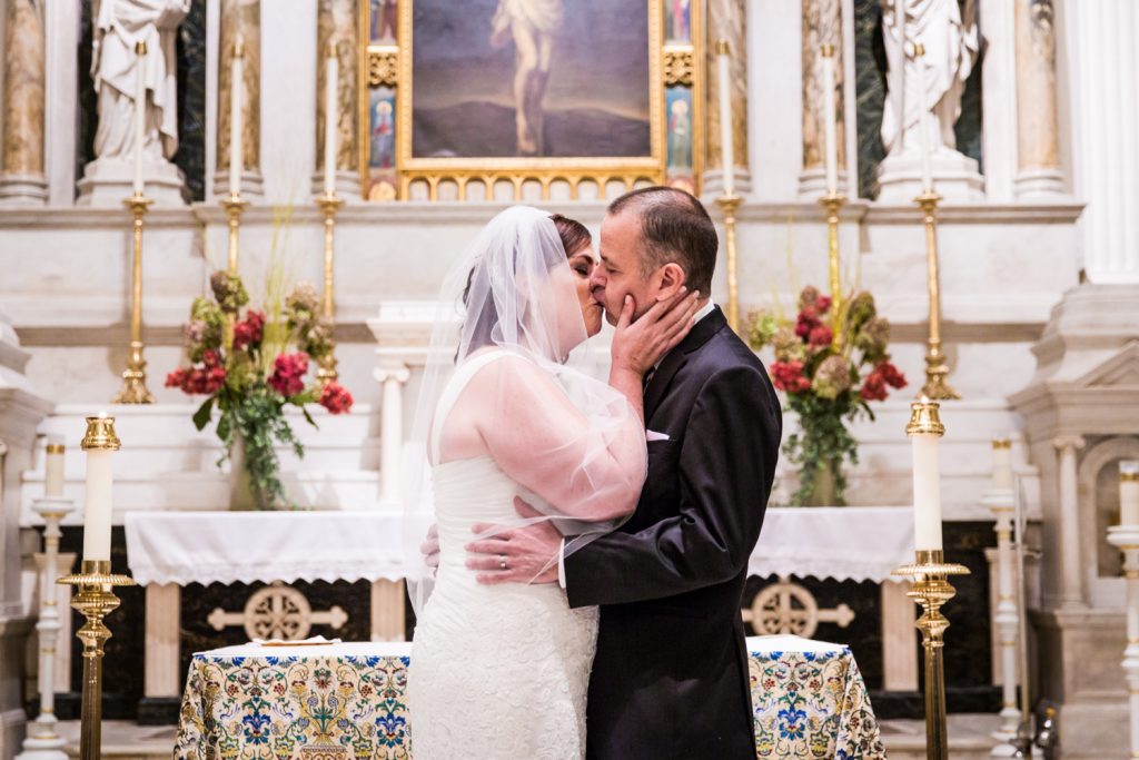 Bride and groom kissing at St. Peter's Church wedding