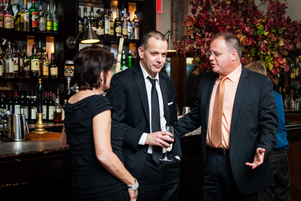 Groom and guests at the bar at a Locanda Verde wedding