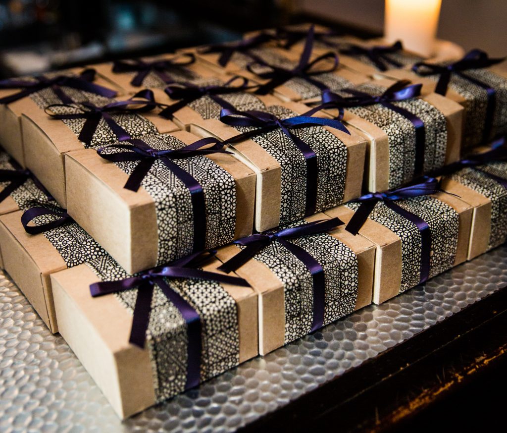 Guest favor boxes with blue ribbons at a Locanda Verde wedding