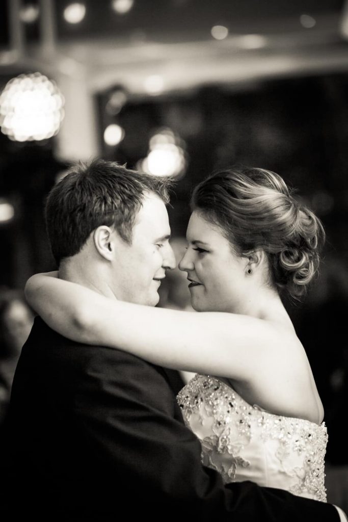 Black and white photo of bride and groom during first dance