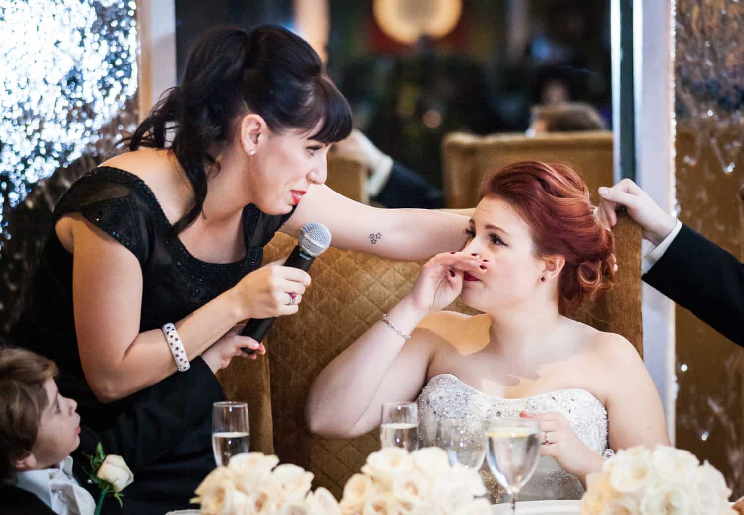 Nicotra's Ballroom wedding photos of bride wiping away tear and listening to speech