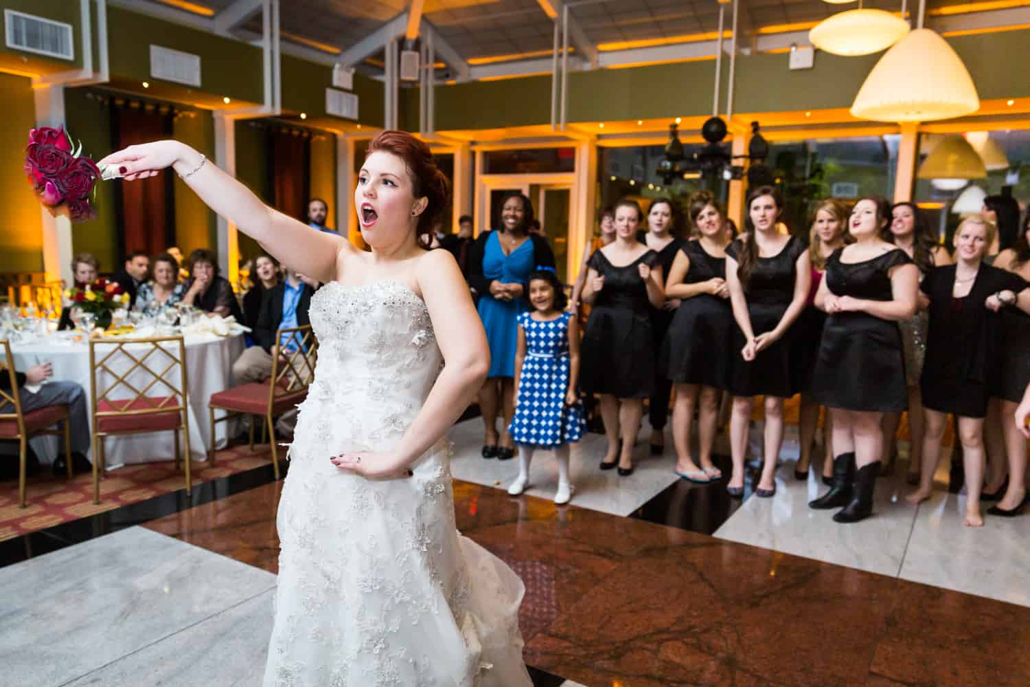 Nicotra's Ballroom wedding photos of bride after throwing bouquet to female guests