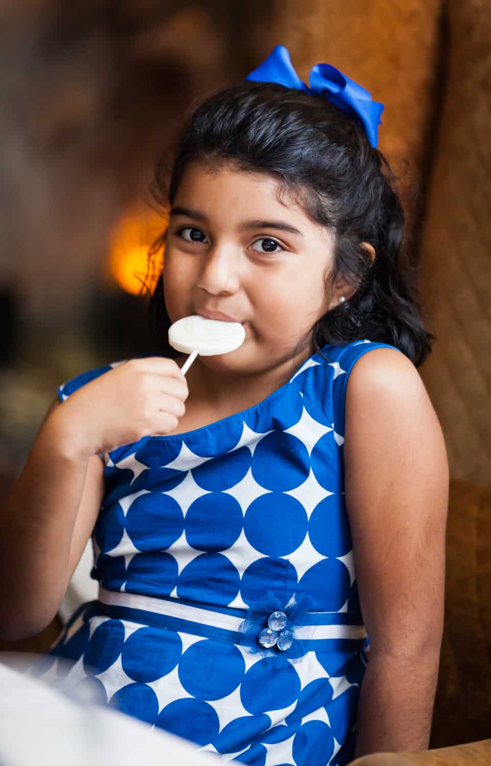 Little girl eating lollipop