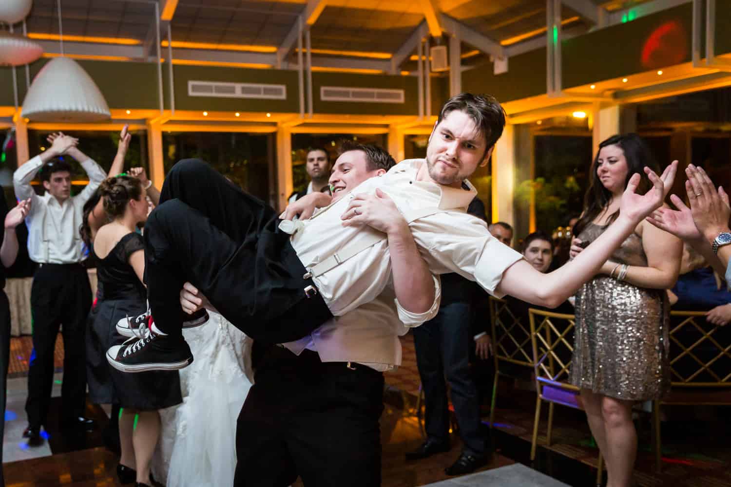 Nicotra's Ballroom wedding photos of groom lifting up groomsman on dance floor