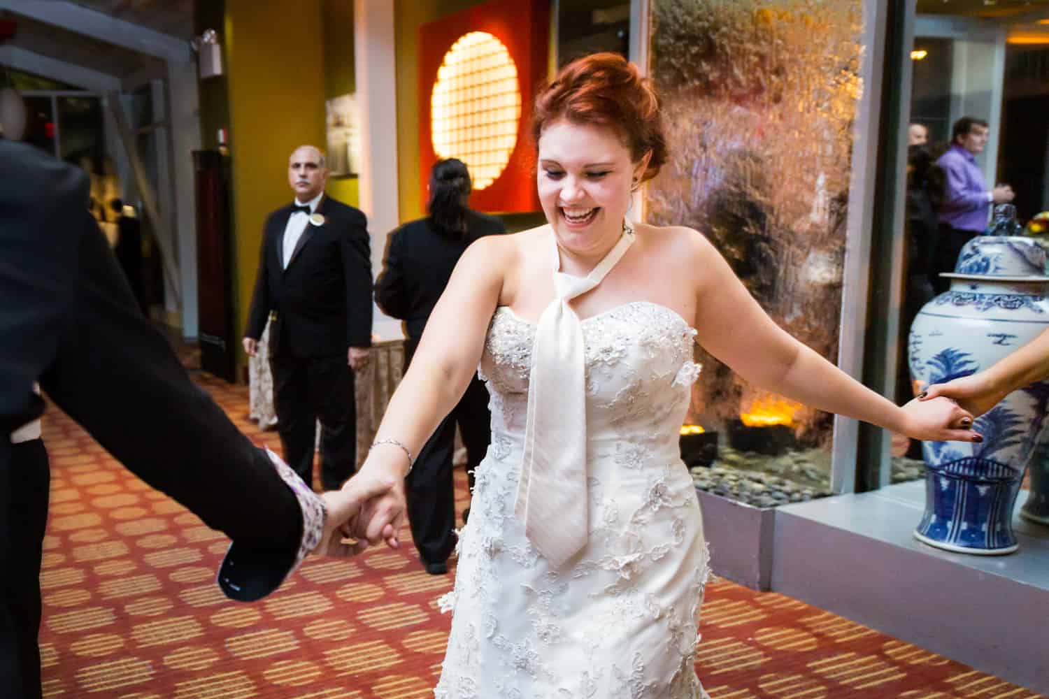 Nicotra's Ballroom wedding photos of bride wearing tie holding hands and dancing