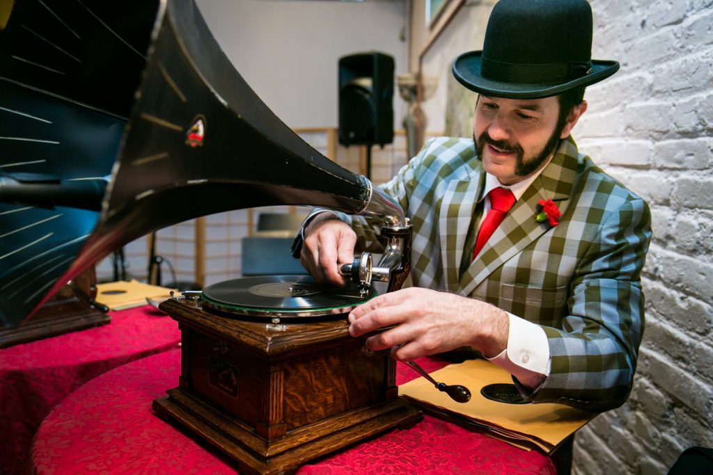 DJ Michael of Michael Cumella's Crank-Up Phonograph Experience playing a record