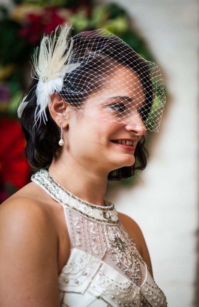 Alger House wedding photos of bride with feathered barrette during ceremony