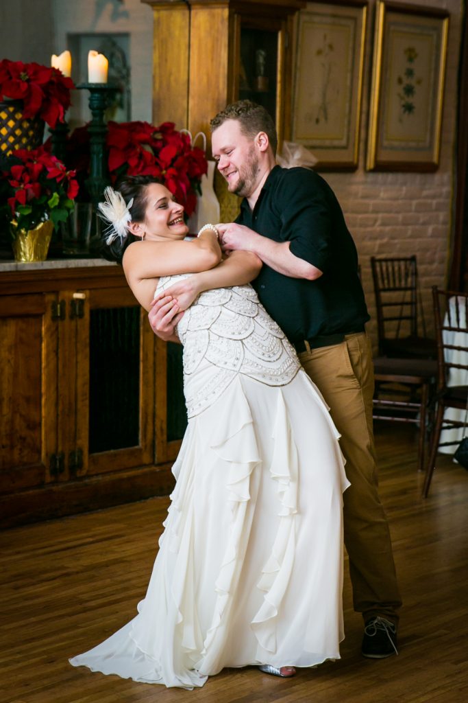 Male guest dipping bride on dance floor