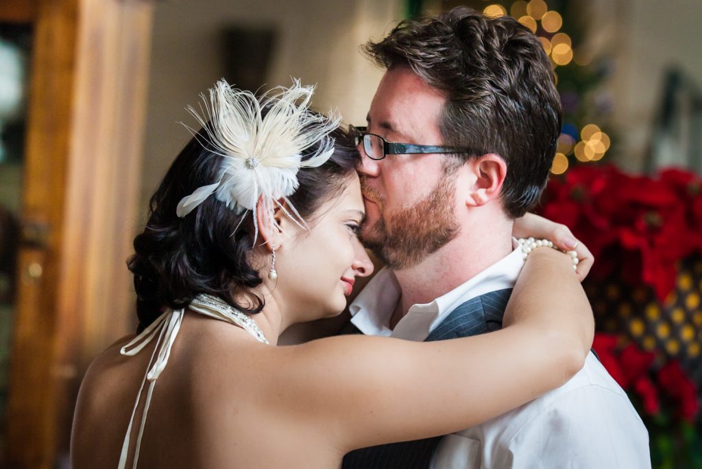 Groom kissing bride on the forehead at an Alger House wedding