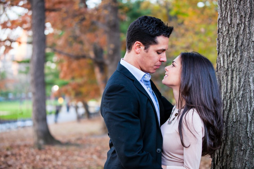 Central Park save-the-date photos of couple with fall foliage in background