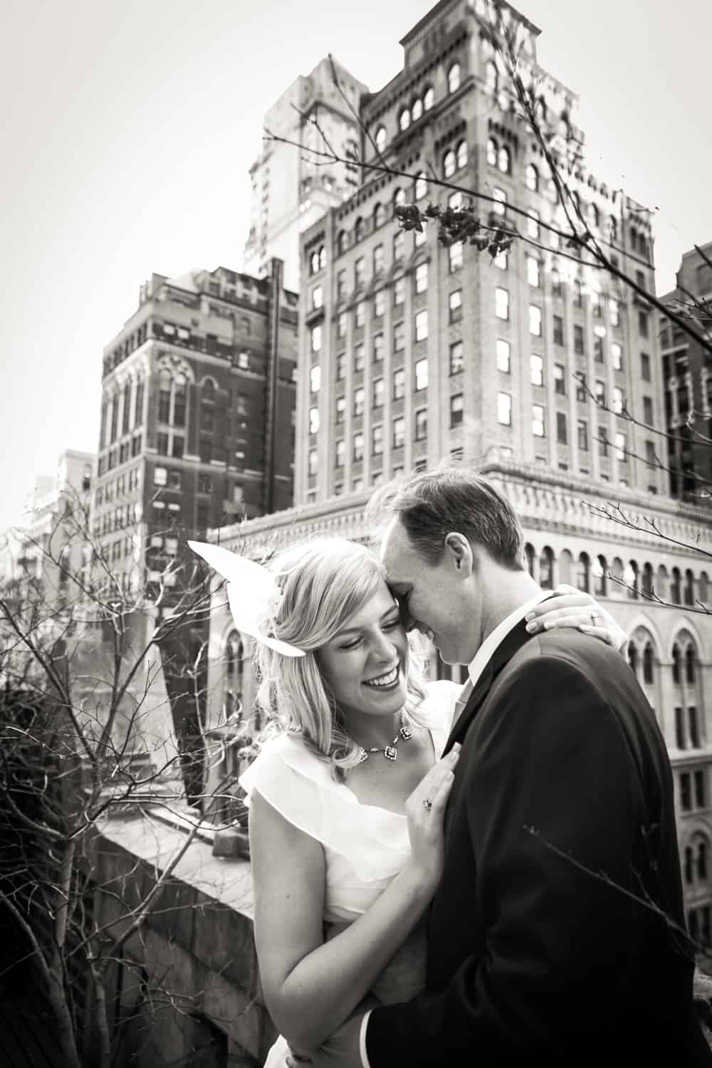 Black and white photo of couple snuggling on balcony of LIbrary Hotel