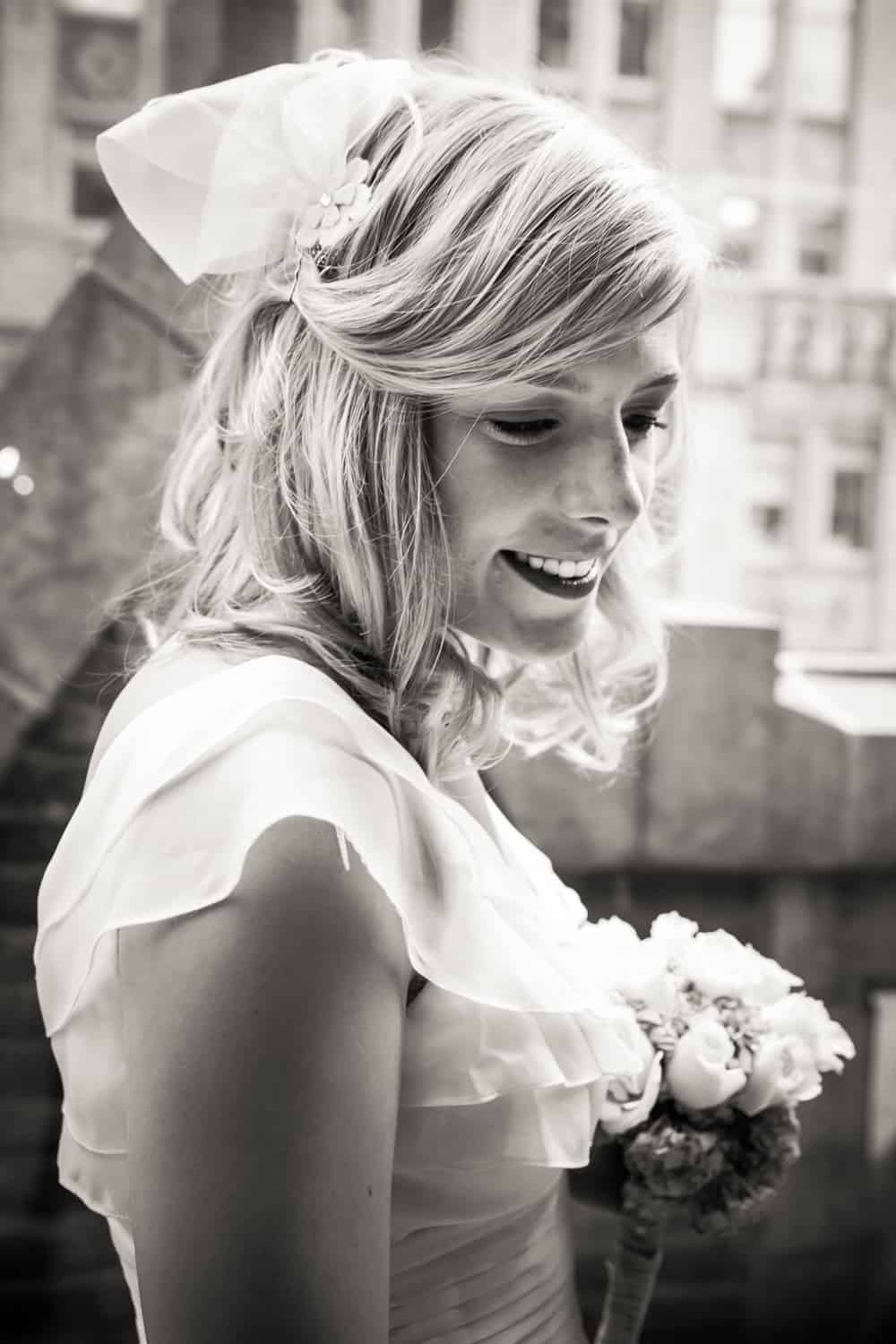 Black and white photo of bride holding bouquet
