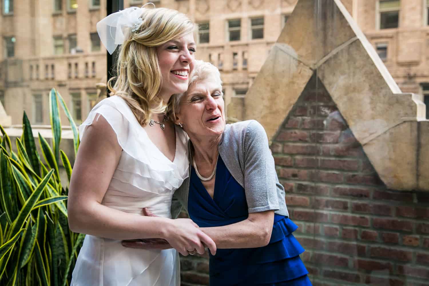Bride hugging her mother on Library Hotel terrace