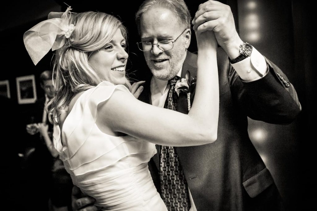 Black and white photo of bride dancing with father at a Library Hotel wedding