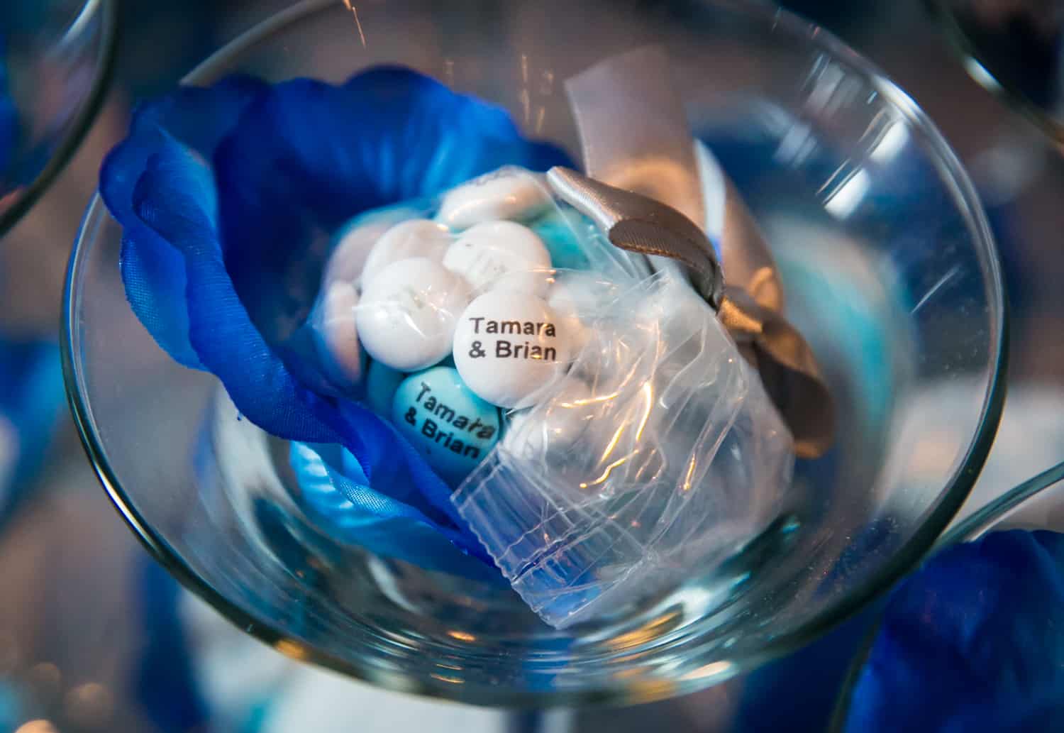 Martini glass holding blue and white M&Ms personalized with 'Tamara and Brian'