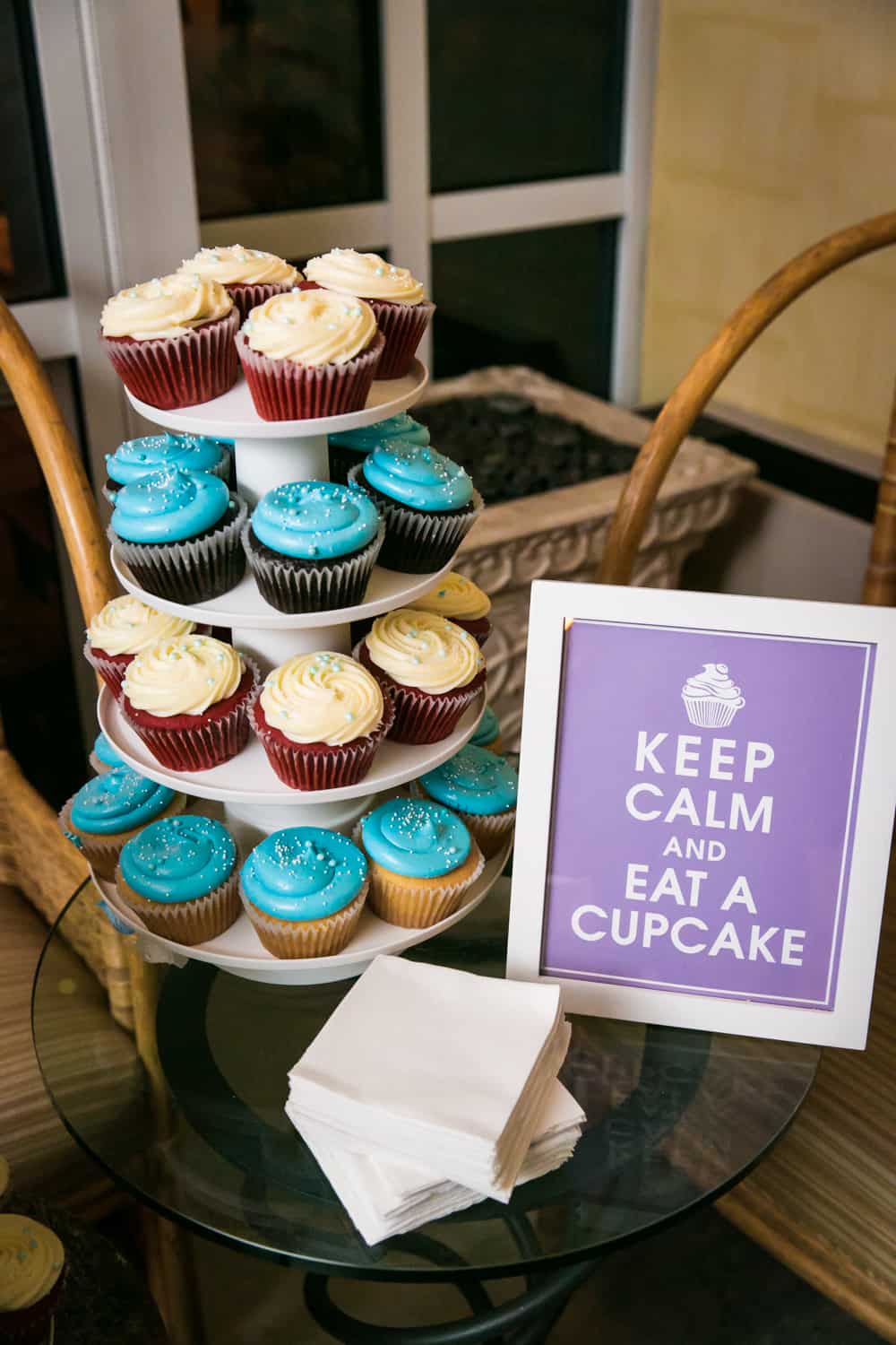 Tier of blue and white cupcakes with sign