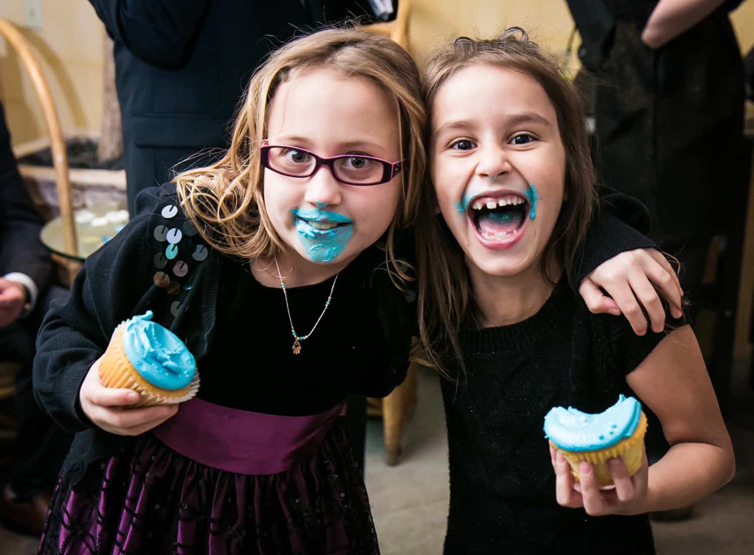 Two little girls with blue icing on their faces at a Library Hotel wedding