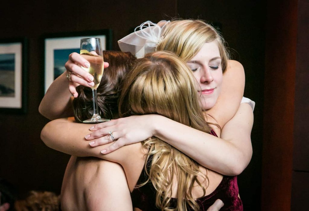 Bride hugging female guests at a Library Hotel wedding
