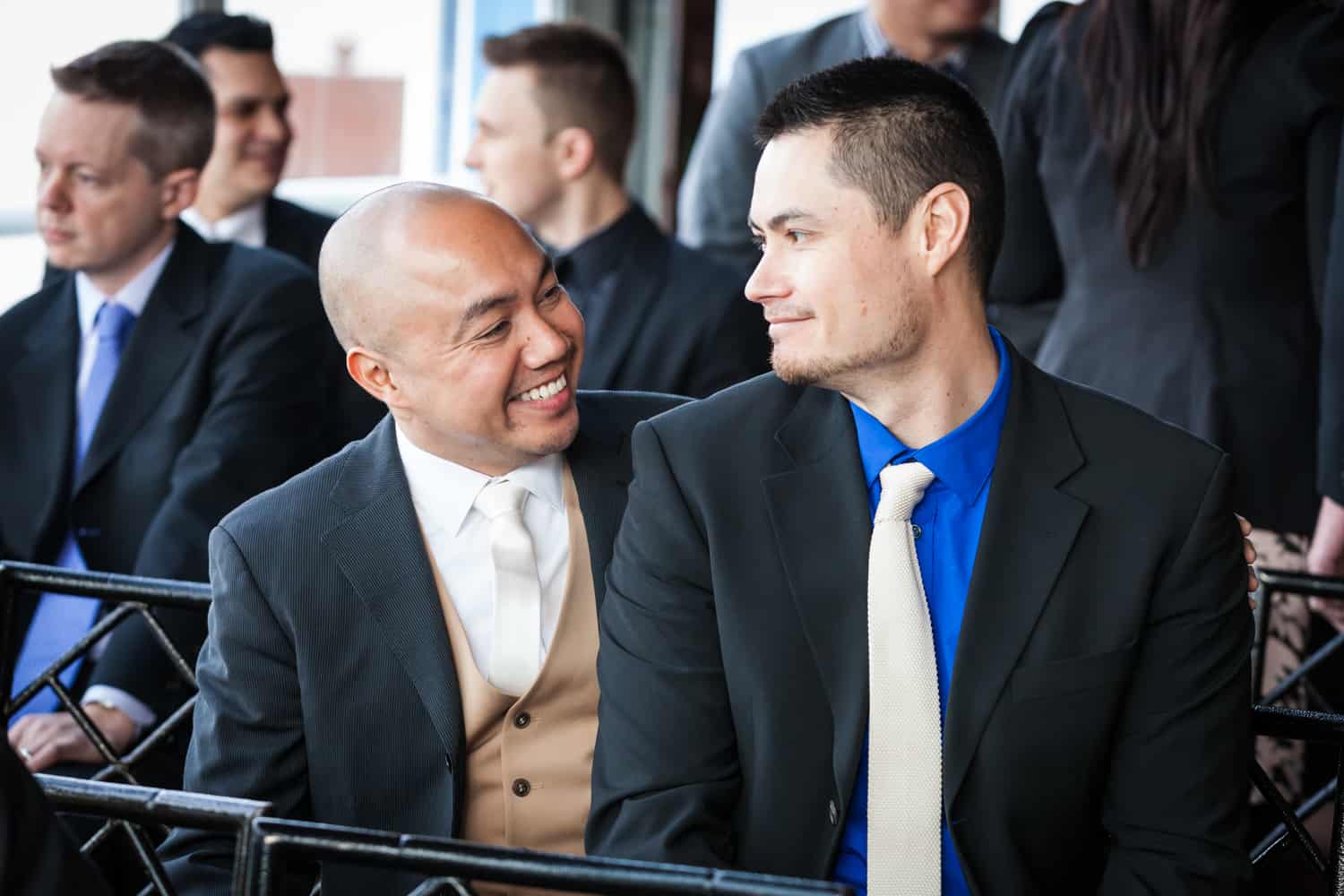 Two male guests before ceremony at a Lighthouse at Chelsea Piers wedding