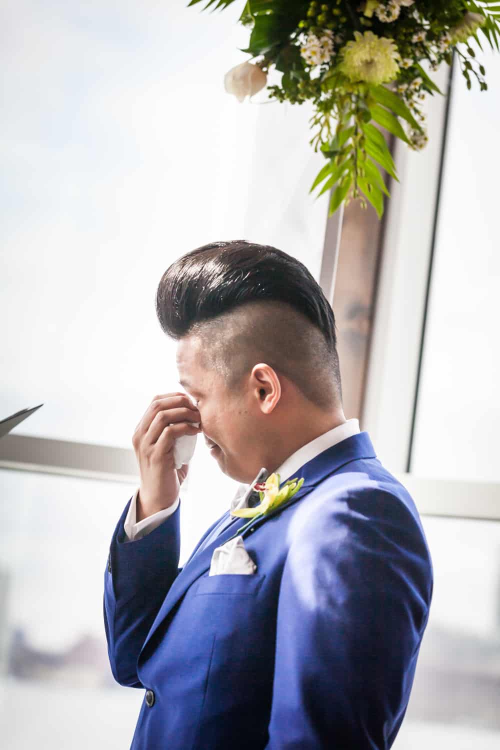 Groom wiping away tear at a Lighthouse at Chelsea Piers wedding