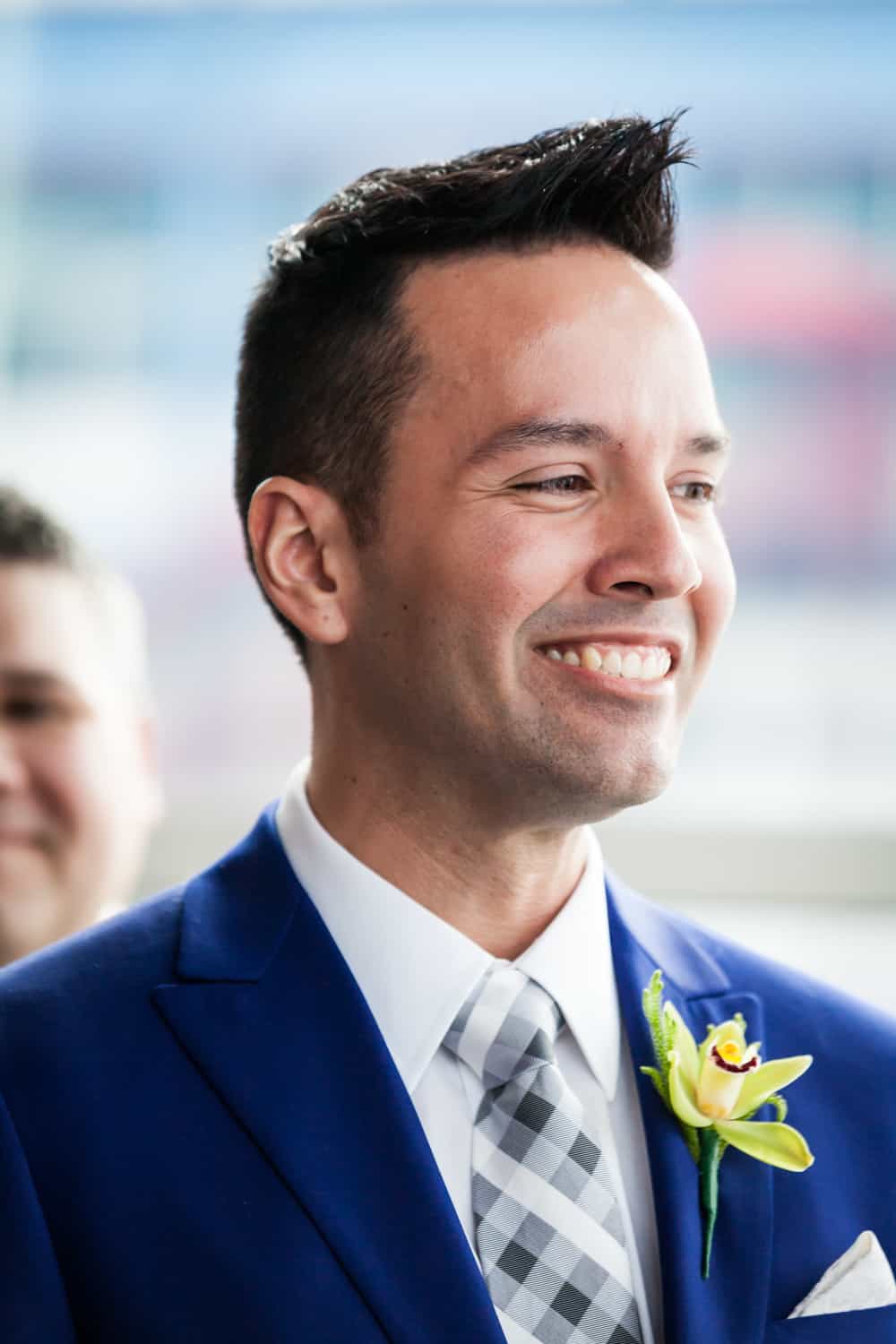 Groom smiling during ceremony at a Lighthouse at Chelsea Piers wedding