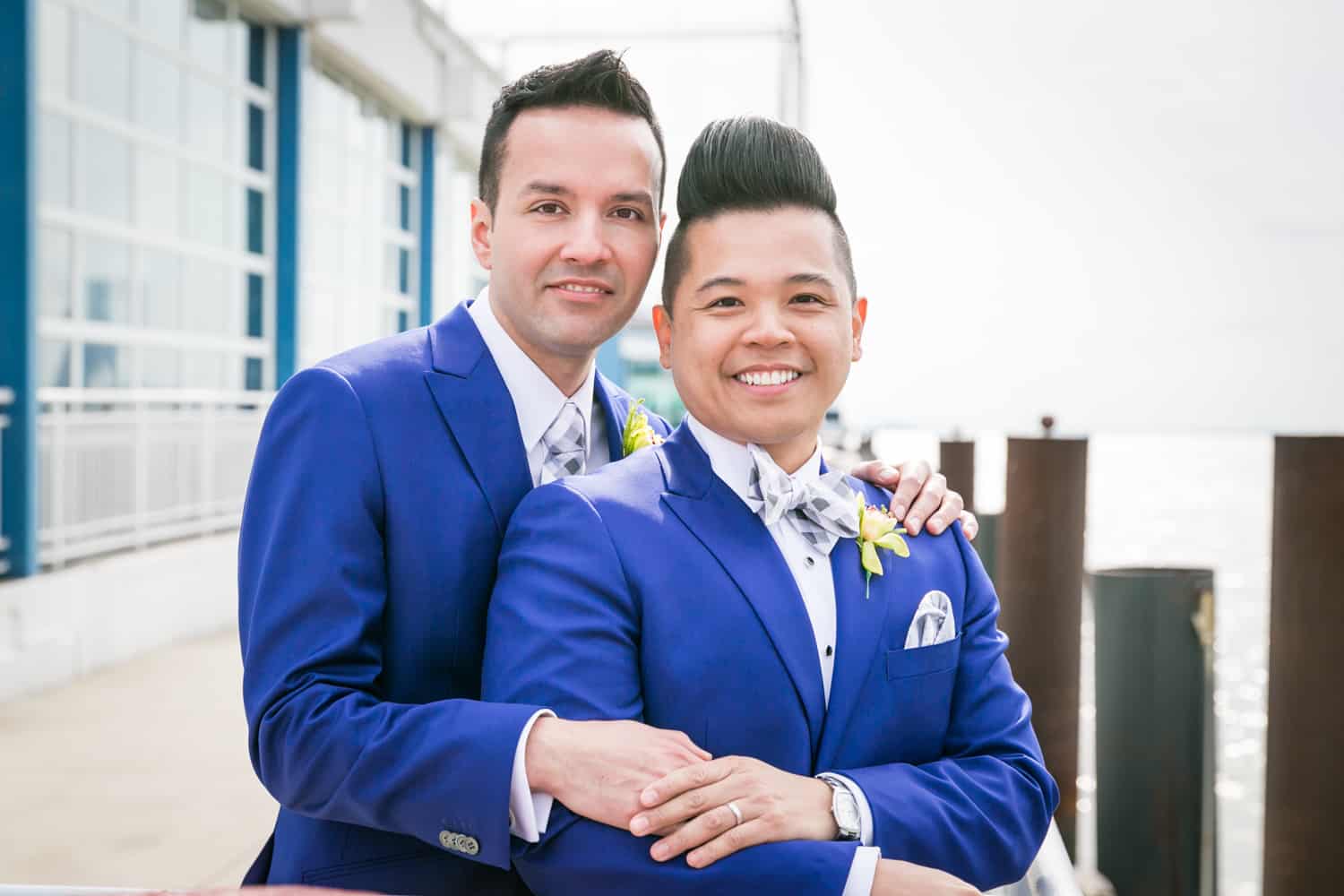 Two grooms beside Hudson River waterfront