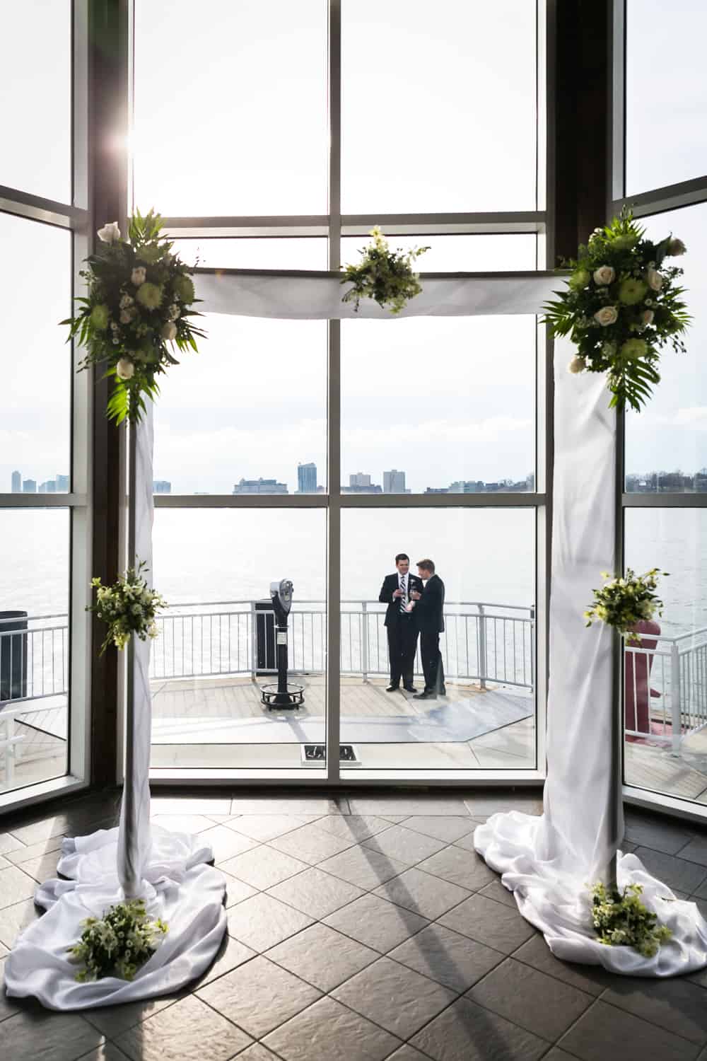 View of Hudson River and two guests outside through altar