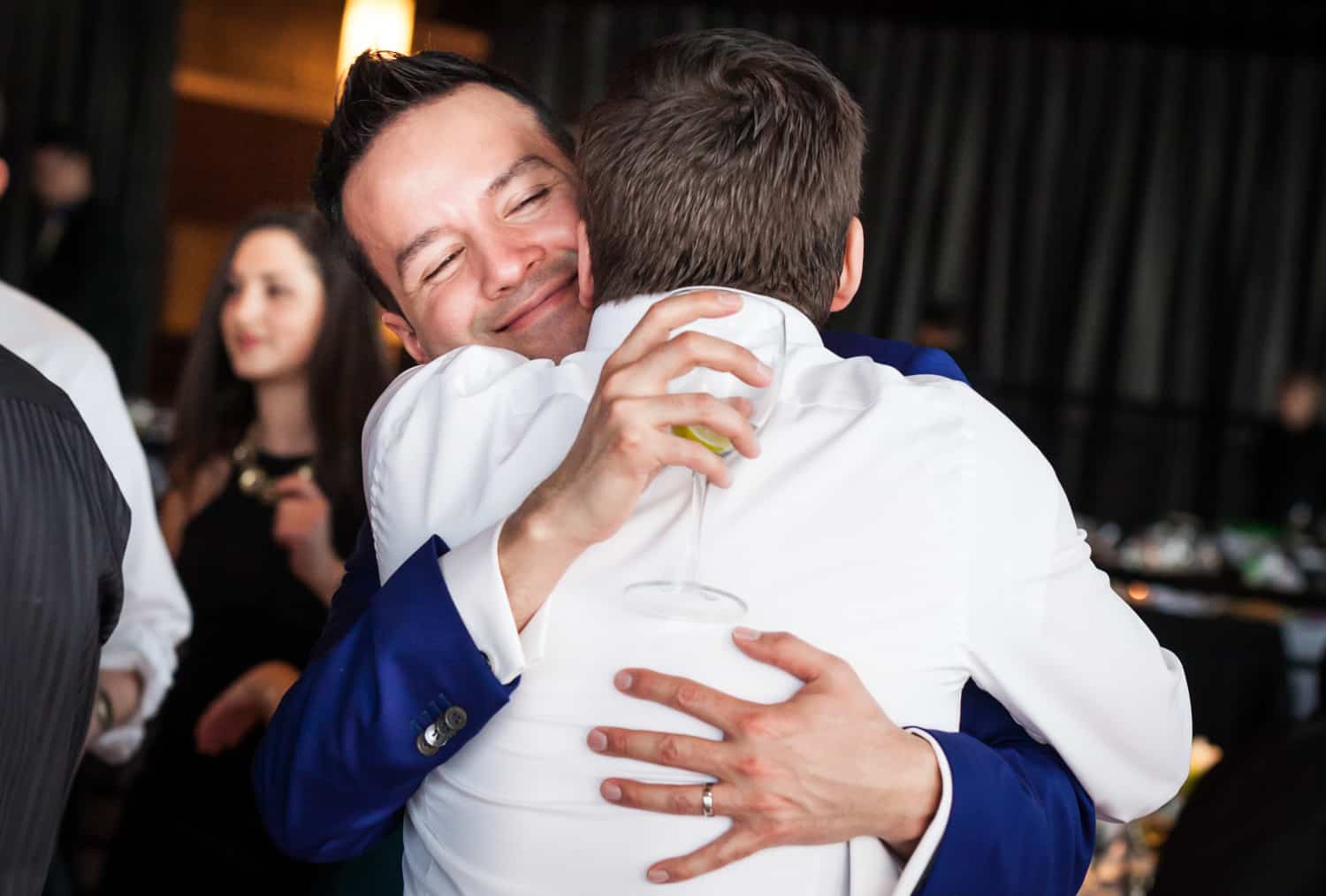 Groom hugging guest at a Lighthouse at Chelsea Piers wedding