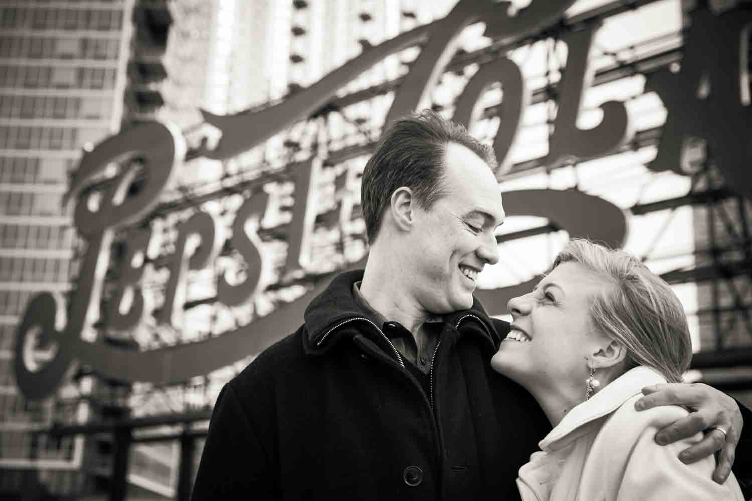 Black and white photo of couple in front of Pepsi Cola sign in Gantry Plaza State Park