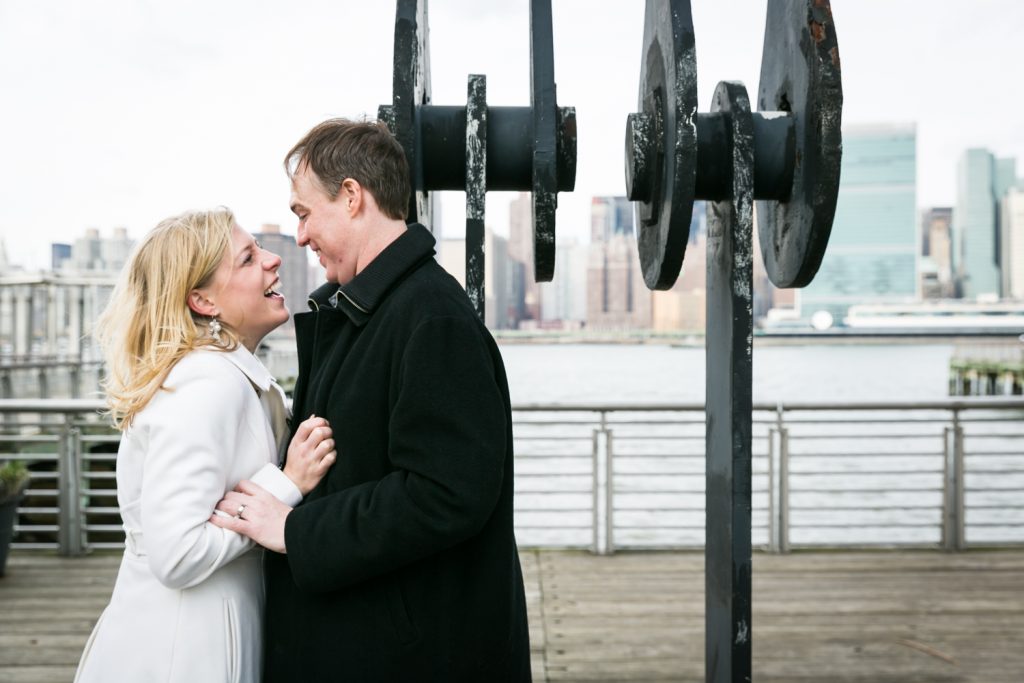 Couple in front of industrial columns in Gantry Plaza State Park