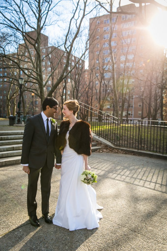 Bride and groom holding hands in Fort Greene Park