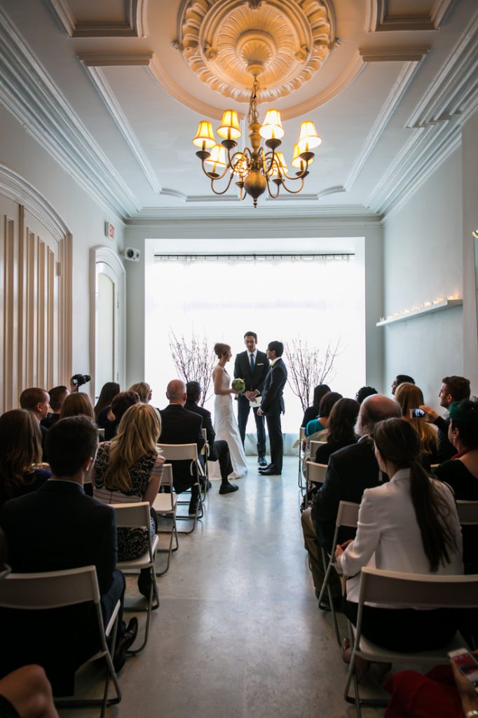 Bride and groom exchanging vows at a Maison May Brownstone wedding