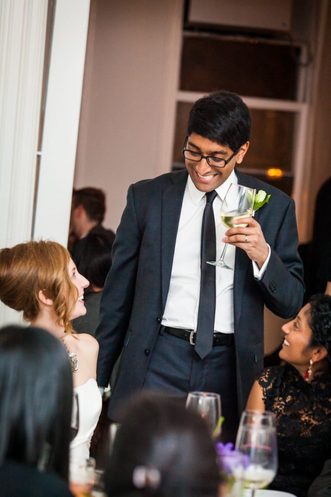 Groom chatting with guests at a Maison May Brownstone wedding
