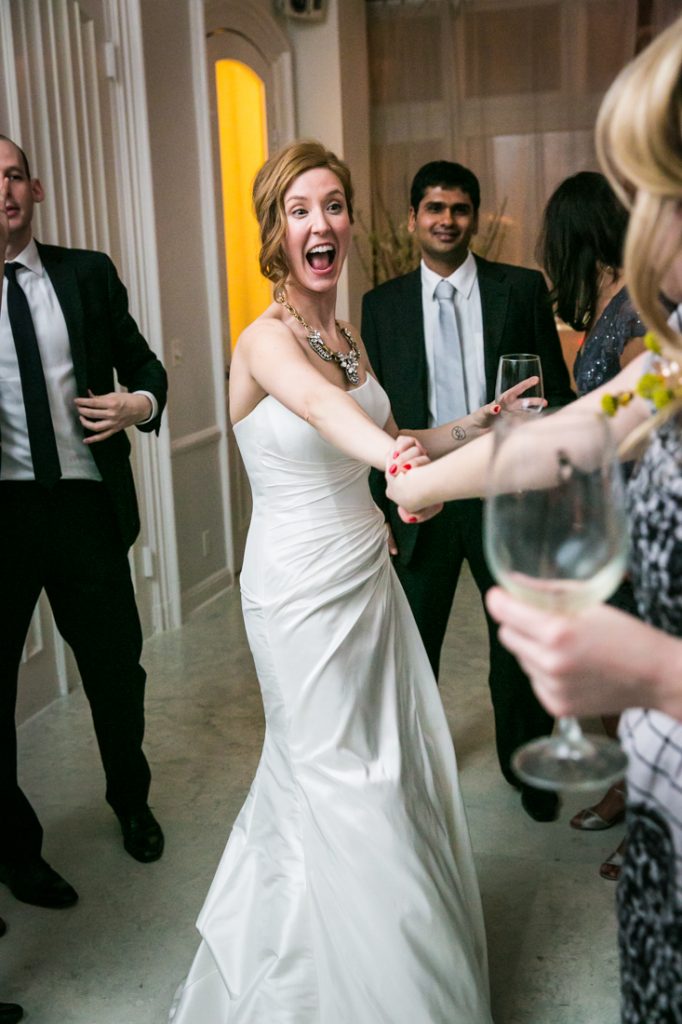 Bride dancing with guest at a Maison May Brownstone wedding