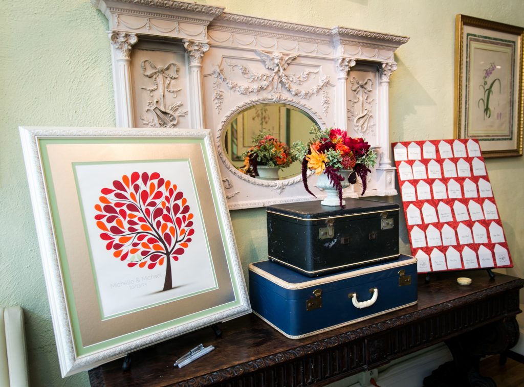 Display of guest book and suitcases, and escort cards