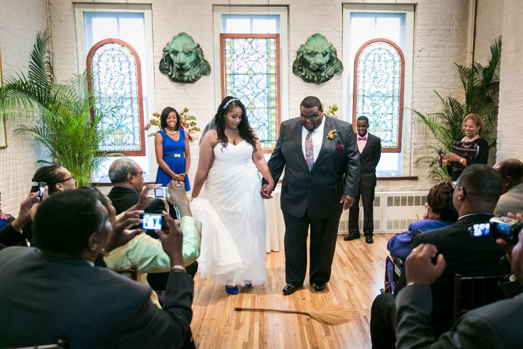 Alger House wedding portraits of bride and groom jumping the broom during ceremony