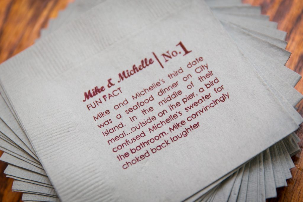 Close up on personalized napkins with story about bride and groom
