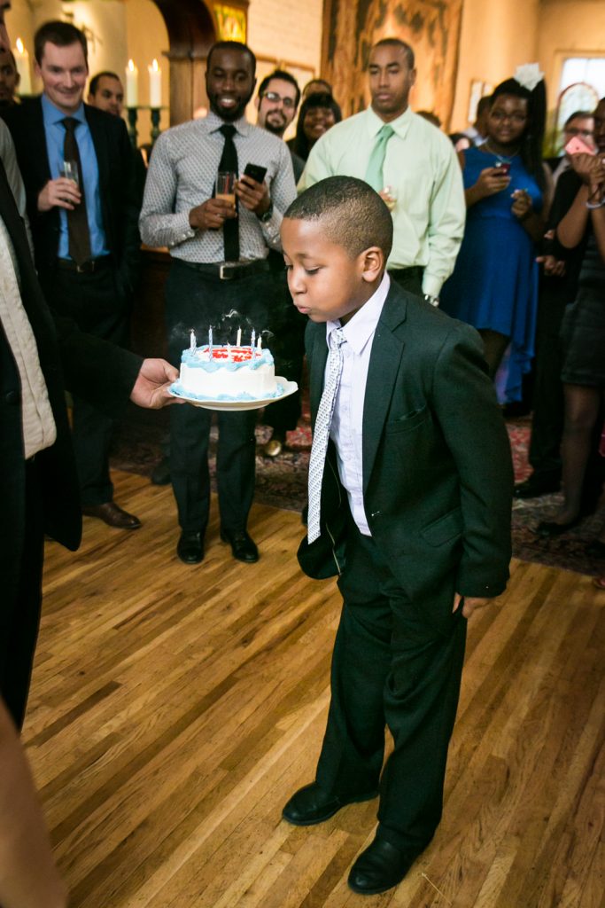 Alger House wedding portraits of young boy blowing out birthday cake