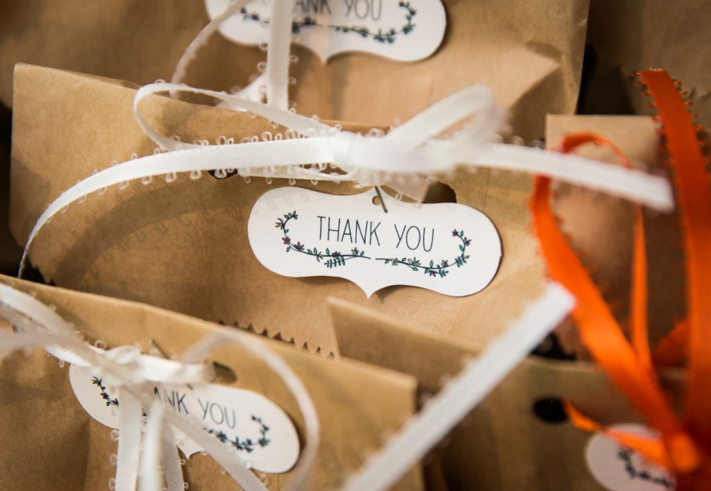 Close up on brown paper bags with 'thank you' tags
