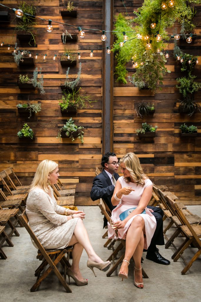 Three seated guests waiting for ceremony to begin at a Brooklyn Winery wedding