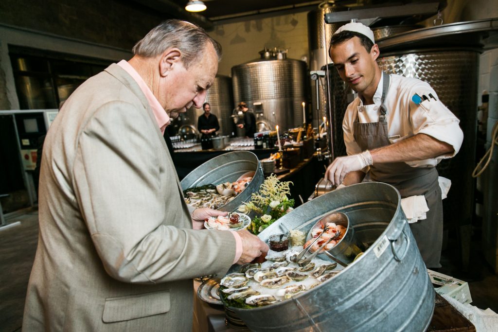 Guest selecting oyster from a buffet at a Brooklyn Winery wedding