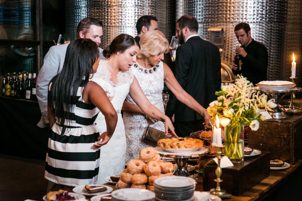 Bride pointing out dessert buffet to guests at a Brooklyn Winery wedding