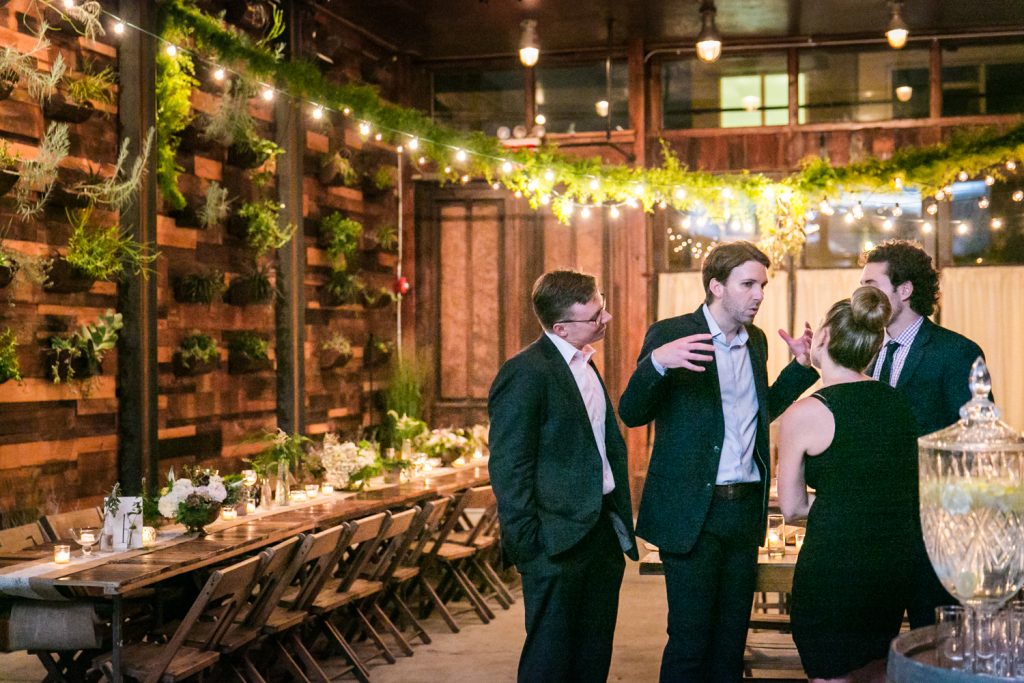 Four guests talking during a Brooklyn Winery wedding reception