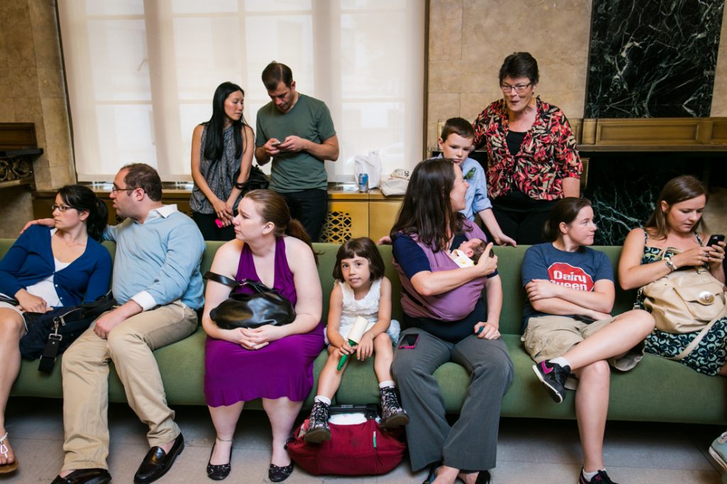People sitting on couch waiting for a NYC LGBTQ City Hall wedding to begin