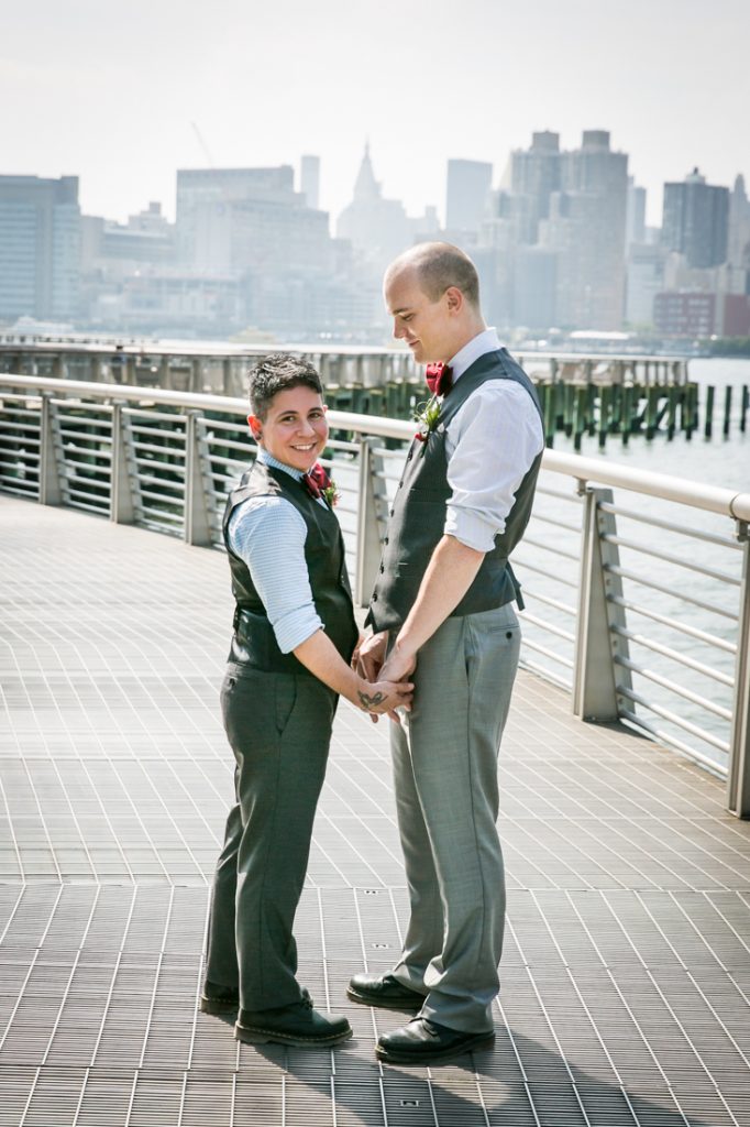 Two grooms holding hands at Gantry Plaza State Park