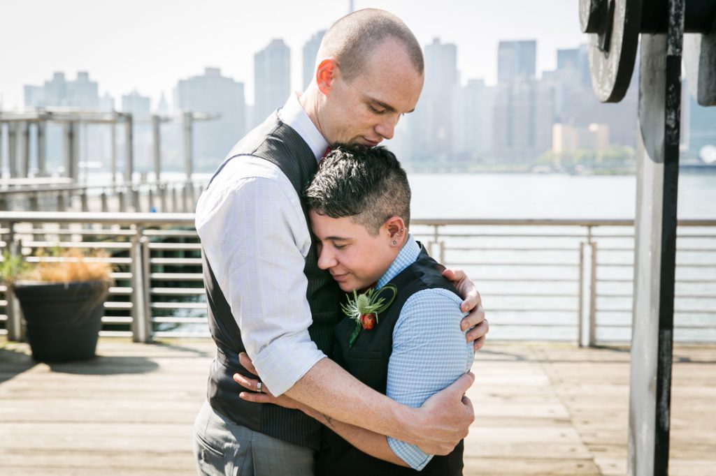 Two grooms hugging at Gantry Plaza State Park