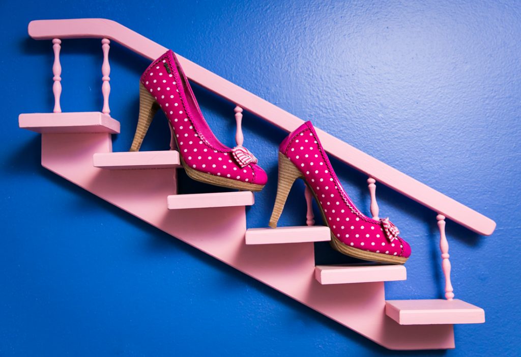 Bride's pink polka dot high heels on pink mini staircase