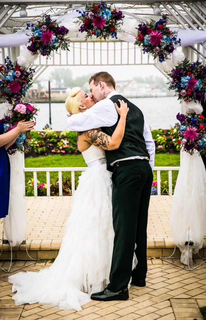 Bride and groom kissing during ceremony at Riviera Waterfront Mansion wedding