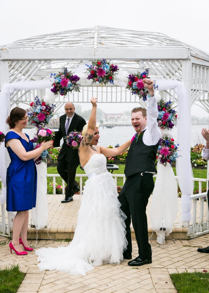 Bride and groom pumping fists after ceremony at Riviera Waterfront Mansion wedding